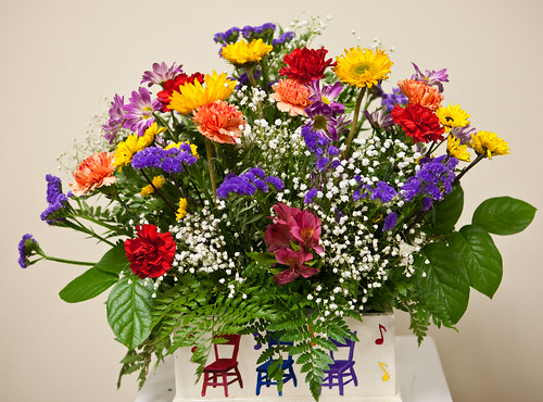 Colorful flower arrangement from boutique flower shop in custom painted vase
