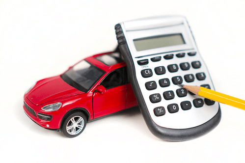 Calculator with pencil on red toy car for auto financing concept