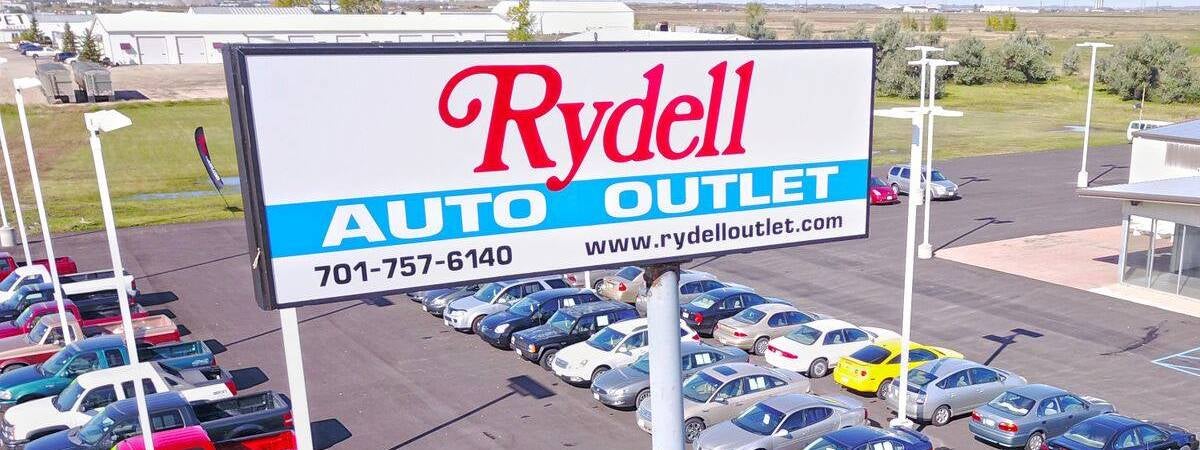 Rydell Outlet sign on used car dealership lot